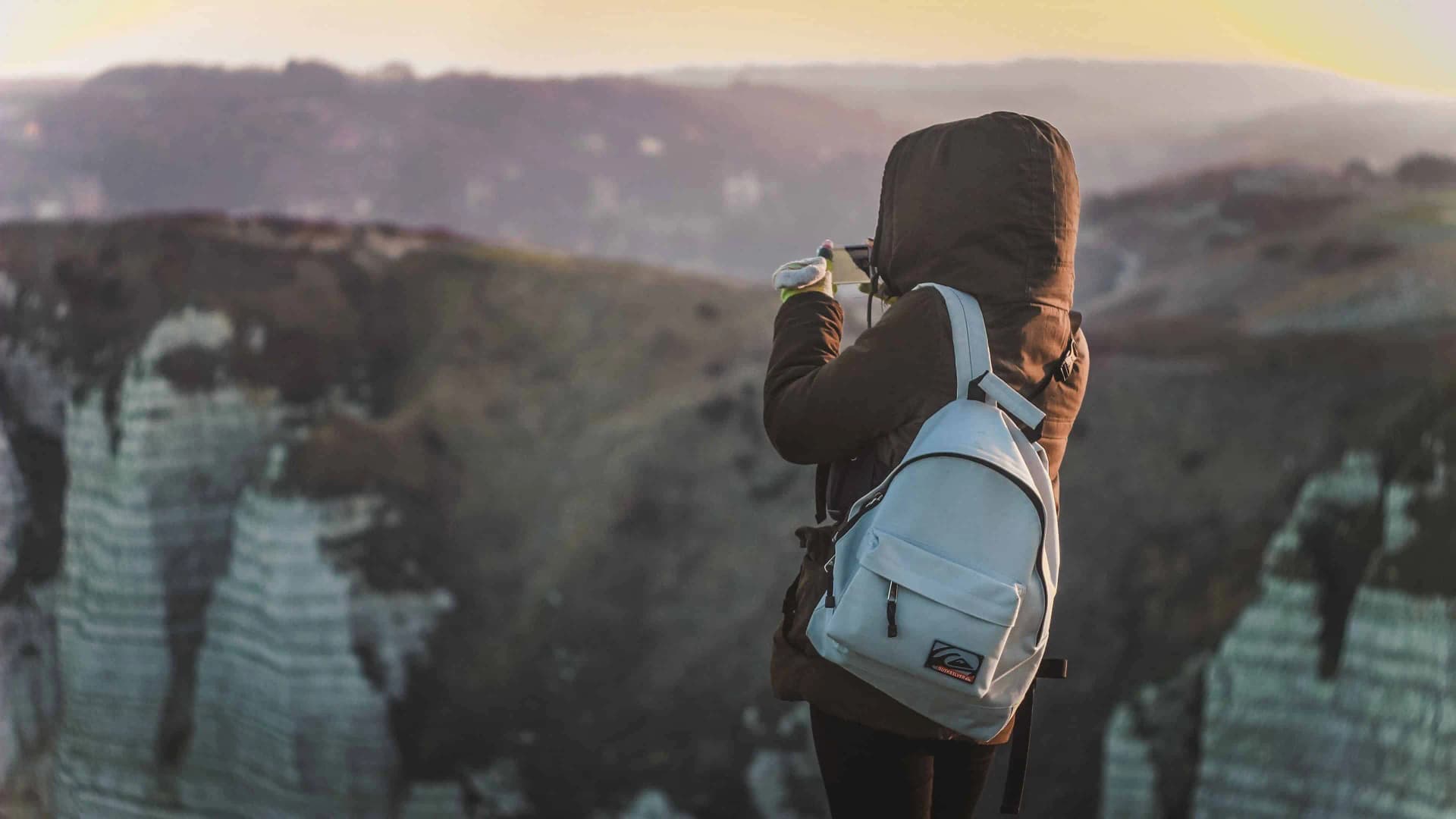 Traveler planning next destination from a scenic viewpoint